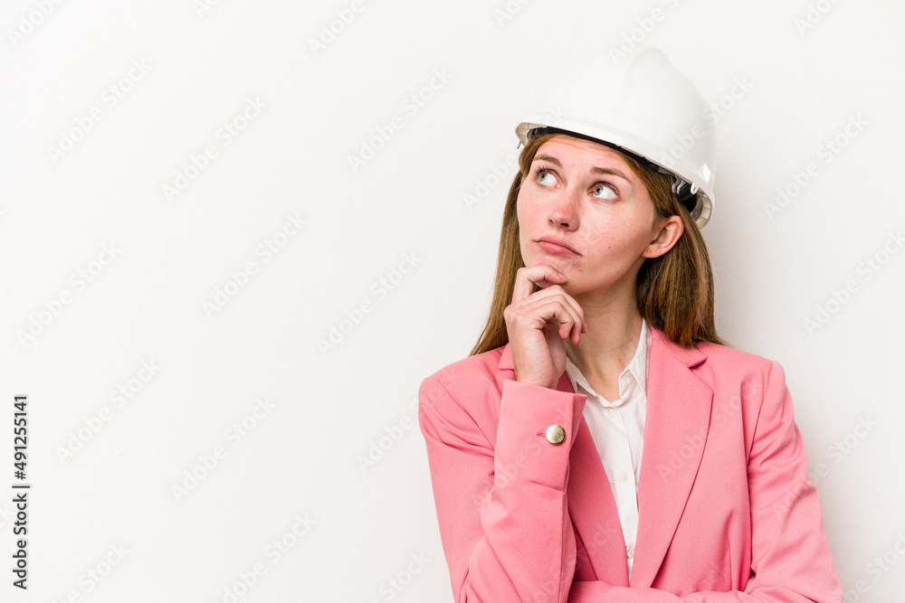 Young architect English woman with helmet isolated on white background looking sideways with doubtful and skeptical expression. Young architect English woman with helmet isolated on white background looking sideways with doubtful and skeptical expression.