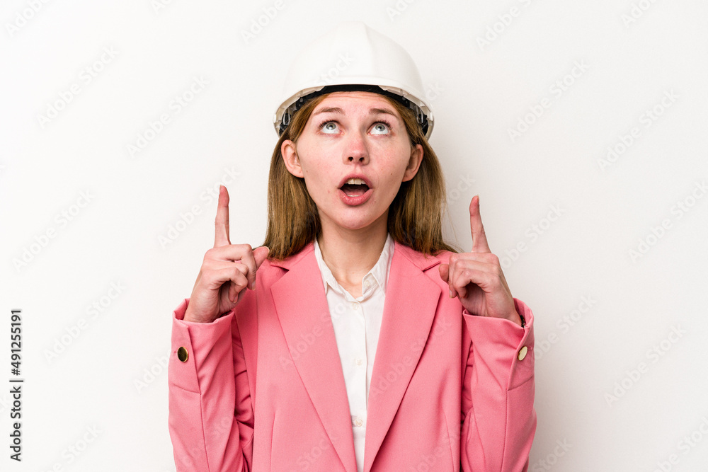 Young architect English woman with helmet isolated on white background pointing upside with opened mouth. Young architect English woman with helmet isolated on white background pointing upside with opened mouth.