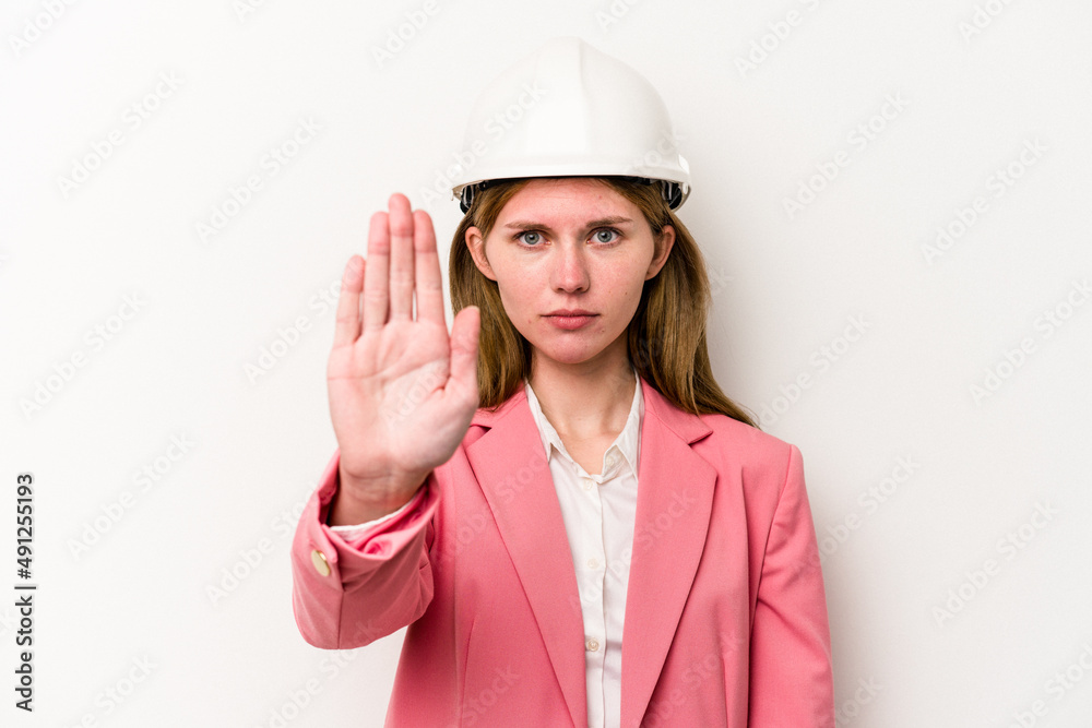 Young architect English woman with helmet isolated on white background standing with outstretched hand showing stop sign, preventing you. Young architect English woman with helmet isolated on white background standing with outstretched hand showing stop sign, preventing you.