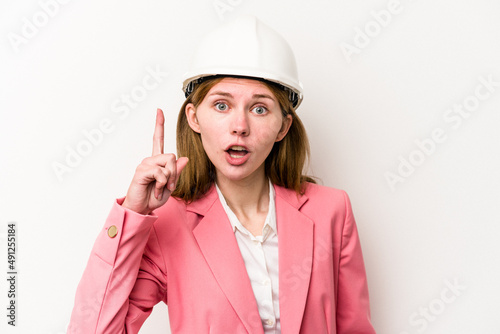 Young architect English woman with helmet isolated on white background having an idea, inspiration concept.