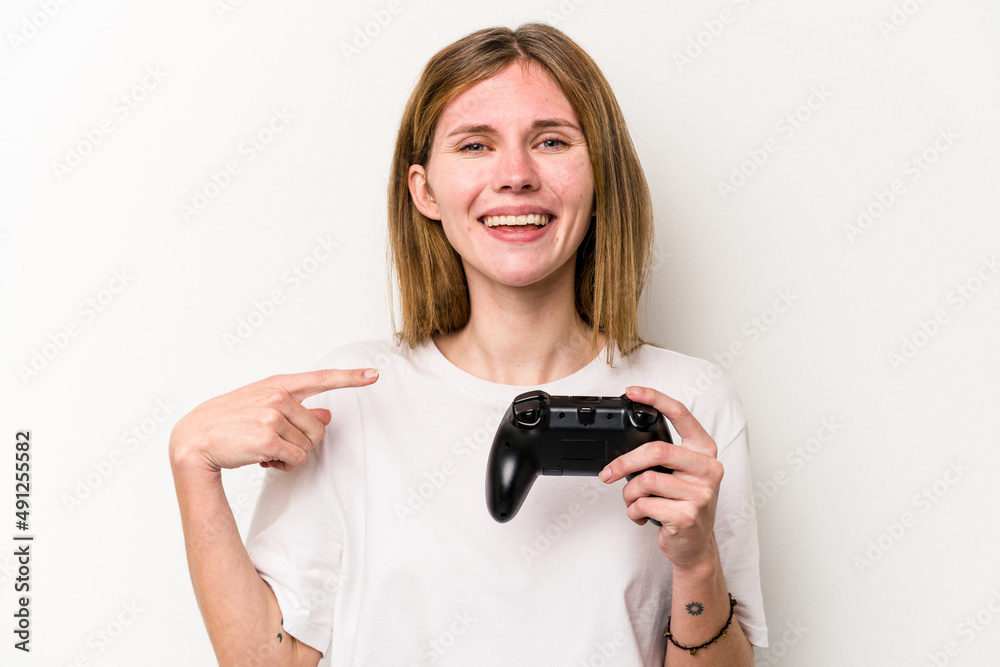 Young English woman playing with a video game controller isolated white background person pointing by hand to a shirt copy space, proud and confident Young English woman playing with a video game controller isolated white background person pointing by hand to a shirt copy space, proud and confident