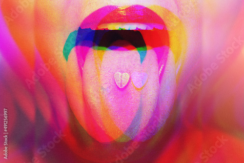 Woman with psychoactive drug pills on her tongue having psychedelic trip with hallucinations photo