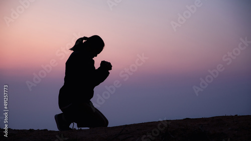 A young woman is praying