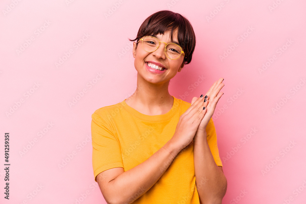 Young hispanic woman isolated on pink background feeling energetic and comfortable, rubbing hands confident. Young hispanic woman isolated on pink background feeling energetic and comfortable, rubbing hands confident.