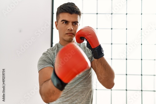 Young hispanic man boxing at sport center © Krakenimages.com