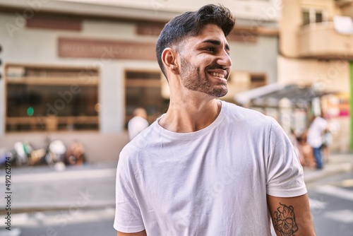 Handsome hispanic man smiling happy outdoors