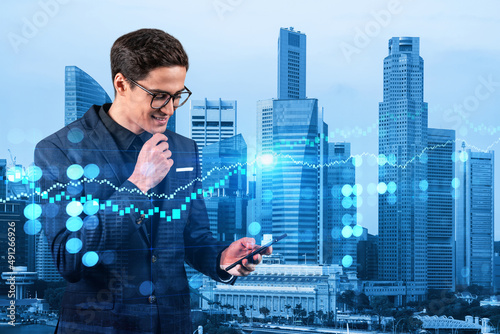 Photography Handsome eastern trader checking quotes to forecast the capital market behavior