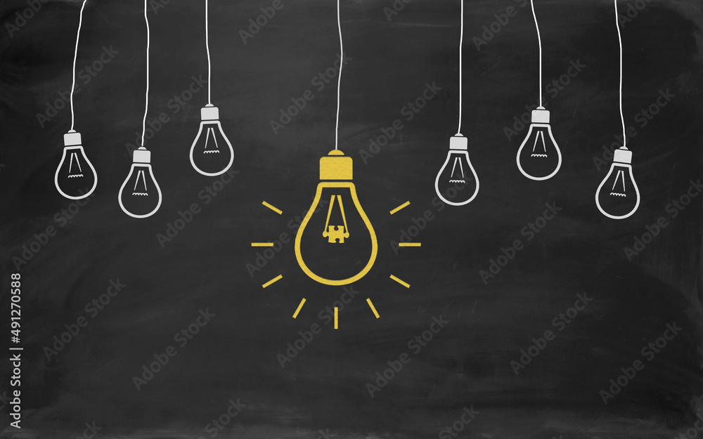 Jigsaw Puzzle Symbol Bulb Concept Drawing with Chalk on Blackboard Jigsaw Puzzle Symbol Bulb Concept Drawing with Chalk on Blackboard
