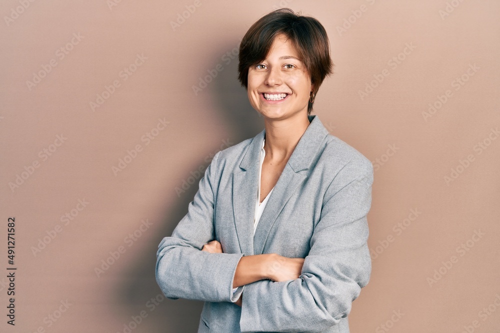 Young business woman smiling happy and confident with crossed arms standing over isolated background Young business woman smiling happy and confident with crossed arms standing over isolated background