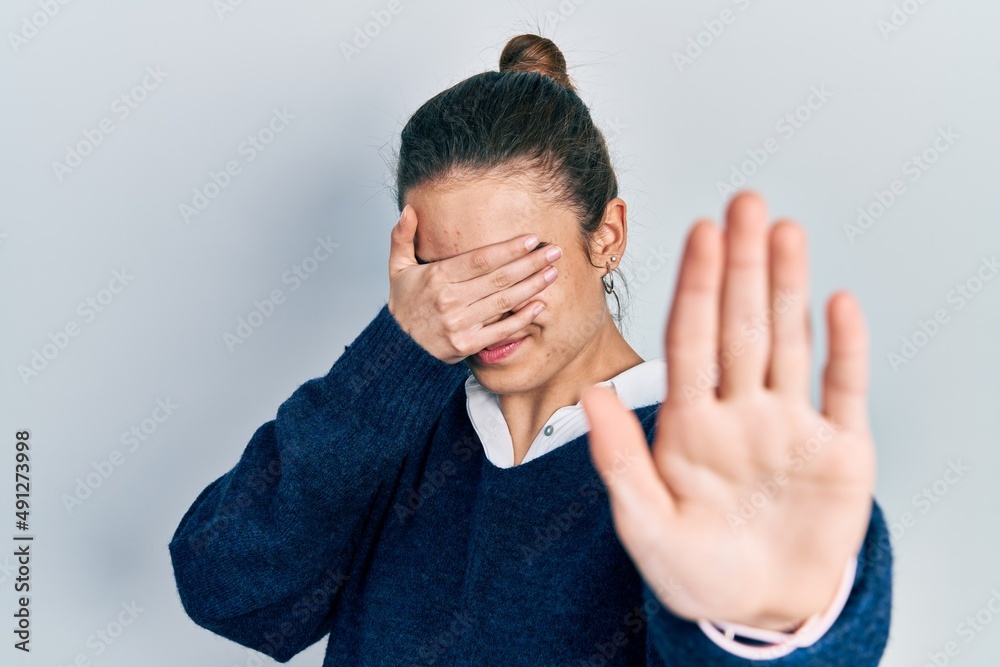Young caucasian girl wearing casual clothes covering eyes with hands and doing stop gesture with sad and fear expression. embarrassed and negative concept. Young caucasian girl wearing casual clothes covering eyes with hands and doing stop gesture with sad and fear expression. embarrassed and negative concept.