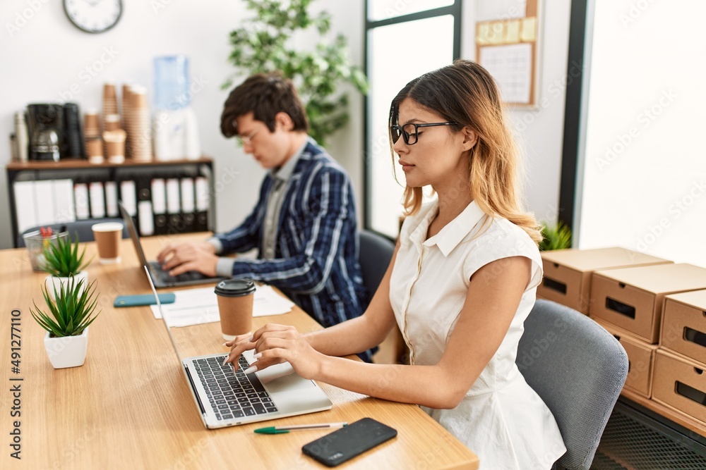 Two business workers with serious expresison working at the office. Two business workers with serious expresison working at the office.