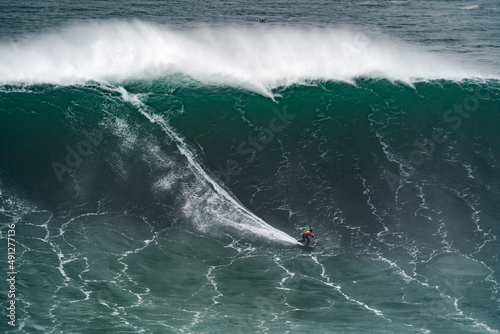 Photography Professional athlete surfing a giant wave.