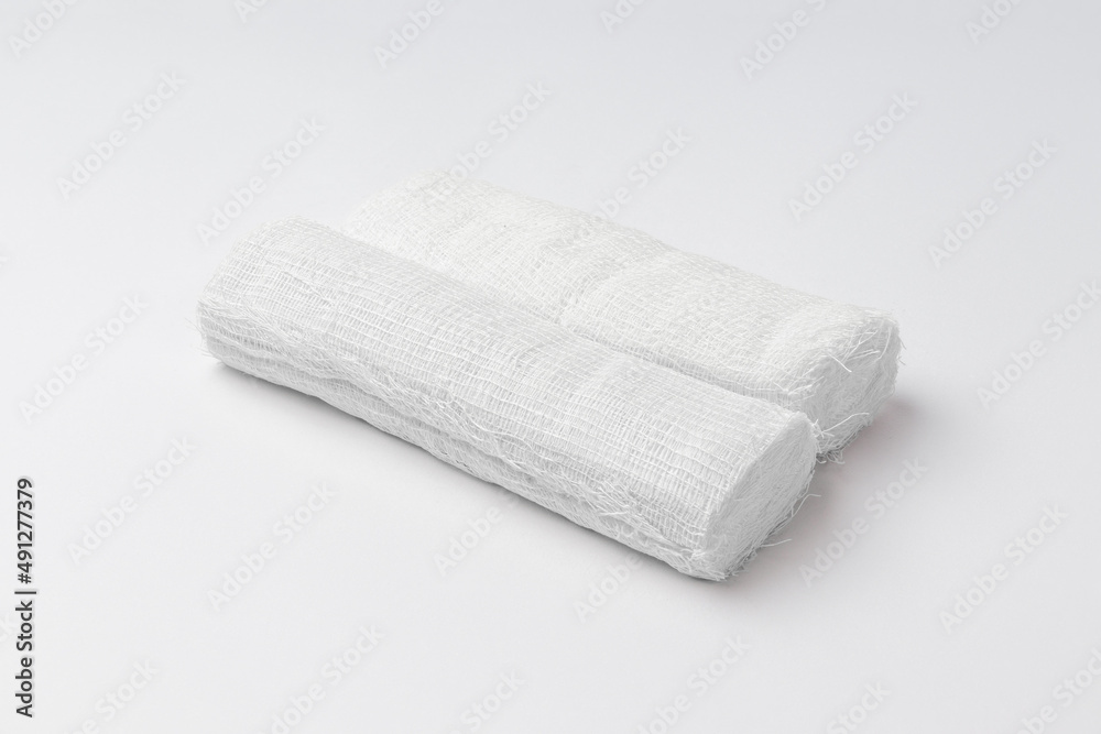 two rolls of white bandage isolated on white background two rolls of white bandage isolated on white background