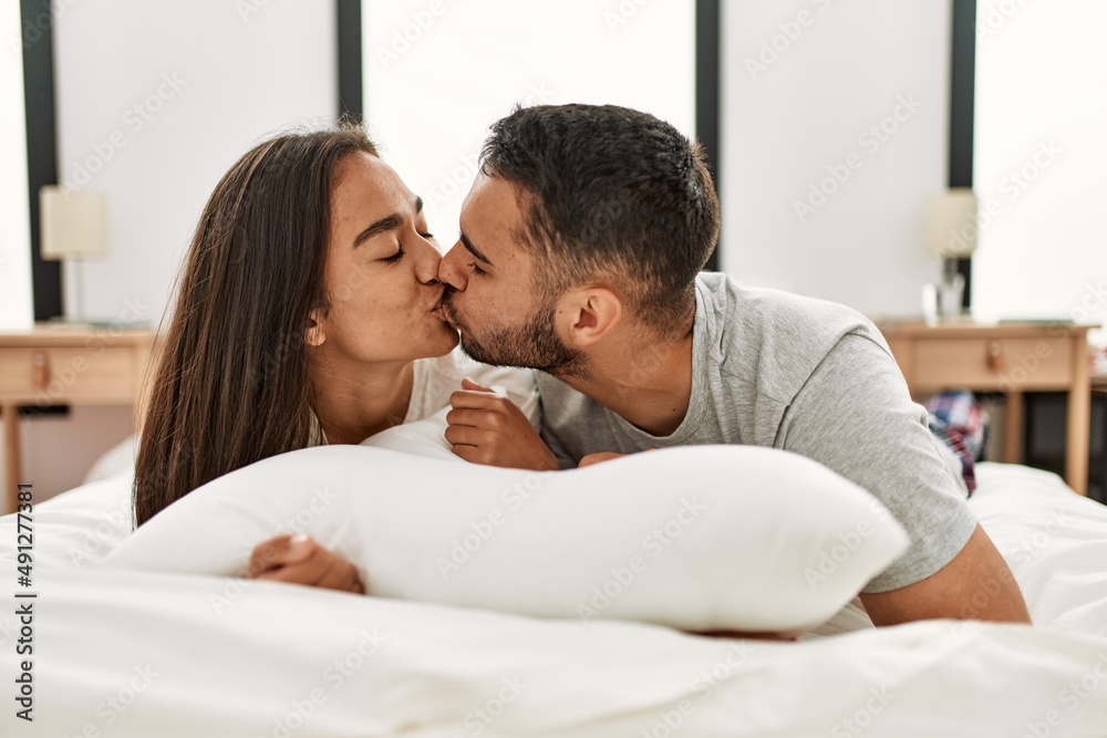 Young latin couple smiling happy hugging on the bed at home. Young latin couple smiling happy hugging on the bed at home.