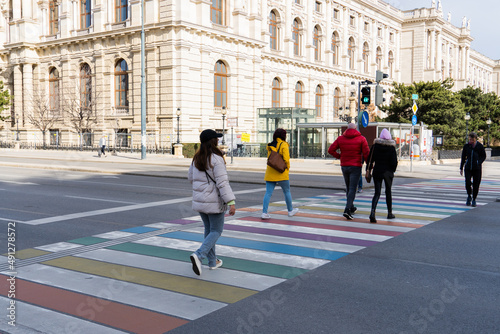 people crossing the rainbow flag zebra crossing in vienna photo