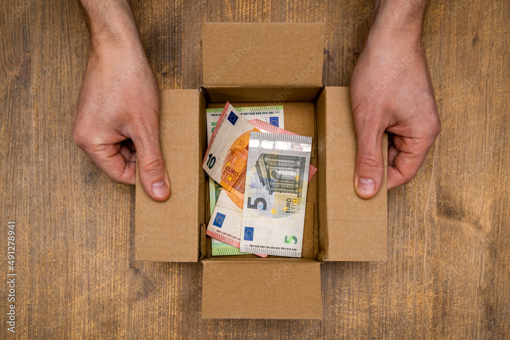 Euro banknotes in open box made from corrugated cardboard. Euro banknotes in open box made from corrugated cardboard.