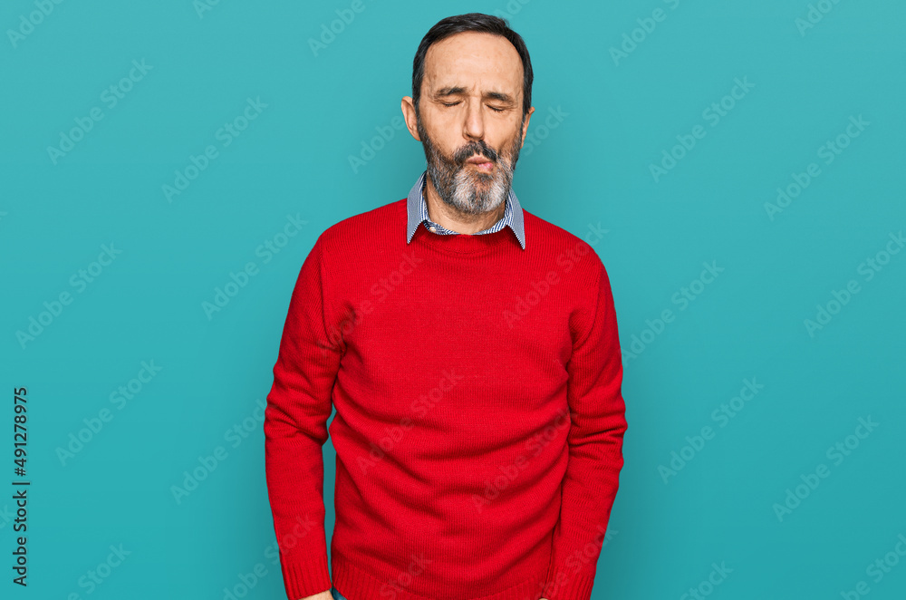 Middle age hispanic man wearing casual clothes making fish face with lips, crazy and comical gesture. funny expression. Middle age hispanic man wearing casual clothes making fish face with lips, crazy and comical gesture. funny expression.