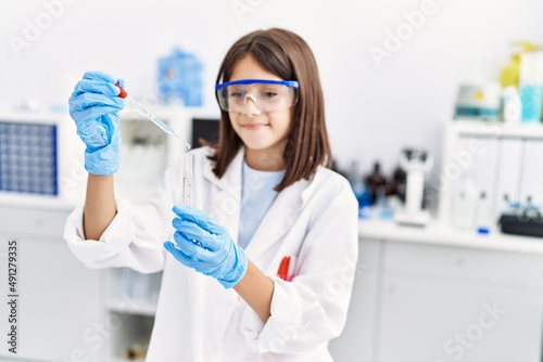 Young hispanic girl working at laboratory