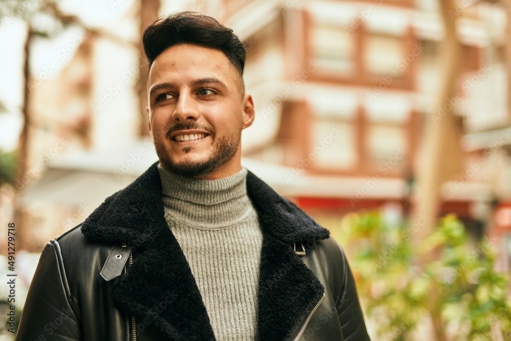 Young arab man smiling happy standing at the city. Young arab man smiling happy standing at the city.