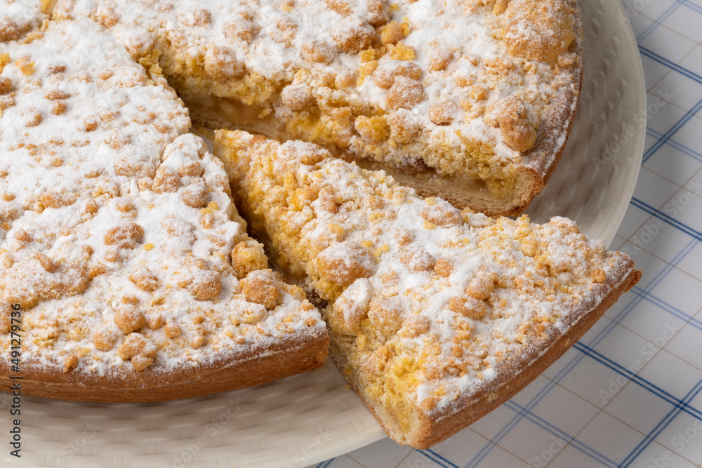 Traditional Dutch Apple crumble cake and a piece close up Traditional Dutch Apple crumble cake and a piece close up