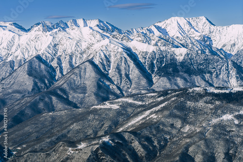 Beautiful view to snow-capped mountains. Scenic mountain landscape with white-snow peaks. Mountains on the background blue sky. Rosa Khutor, Caucasus Mountains.  © Ksenya