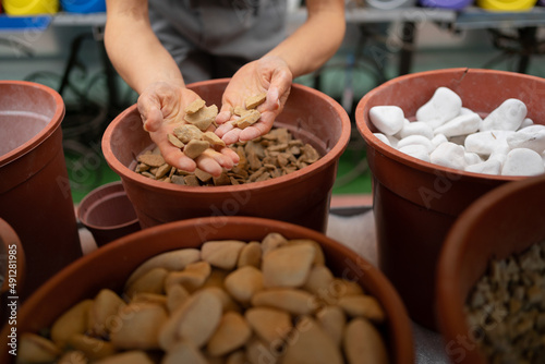 Many decorative natural stones are sold in the construction market. Construction Materials. of female hands chooses stones for decoration. © mtrlin