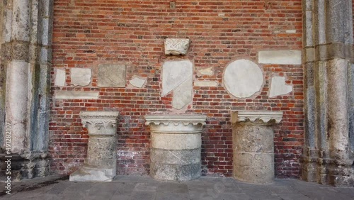 archaeological finds from the Greek-Roman age with columns, capitals in Ionic, Doric and classical style in Sant'Ambrogio Church in Milan Italy Heritage  photo