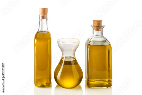 Bottles and decanter of extra virgin olive oil isolated on white, clipping path