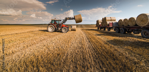 Bale on tractor trailer in farm field