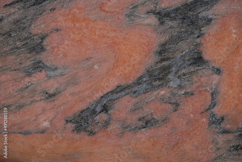 Natural stone background. Dark gray and coral colors.