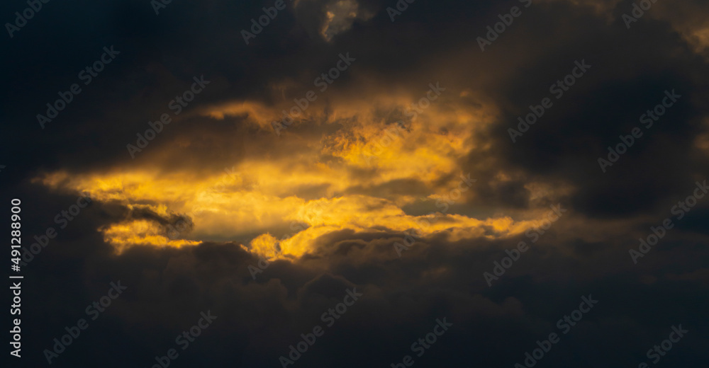 Dark cloudy landscape. Light through the clouds. Heaven background. Sunlight. Religion concept.