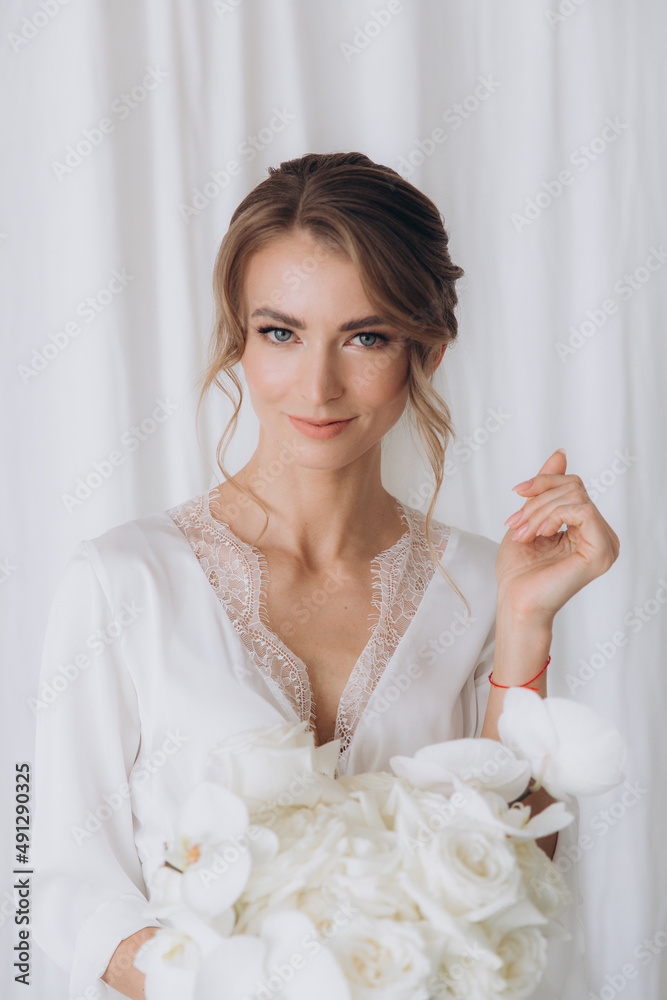 Morning of the bride in a rustic style, in a white bathrobe and a white bouquet on the bed and in the bathroom by the window in a photo studio, in a hotel Morning of the bride in a rustic style, in a white bathrobe and a white bouquet on the bed and in the bathroom by the window in a photo studio, in a hotel