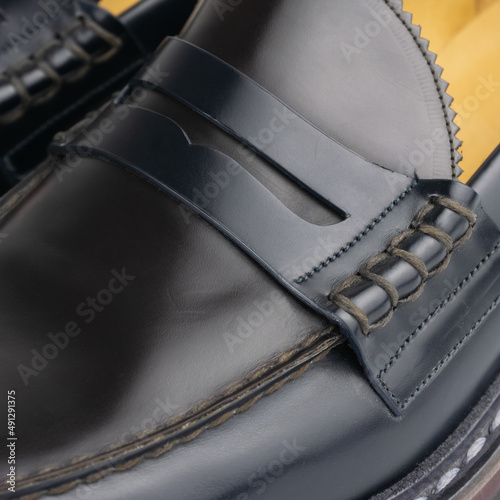 Dark blue - burgundy penny loafers detail closeup © Anastasiia