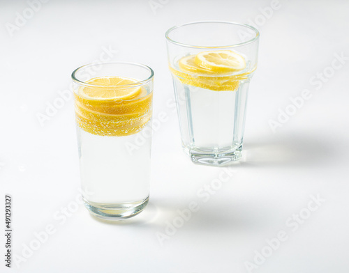 Two glasses with fresh lemon water or homemade lemonade