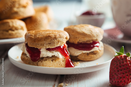 Delicious scones with clotted cream and strawberry jam for tea time photo