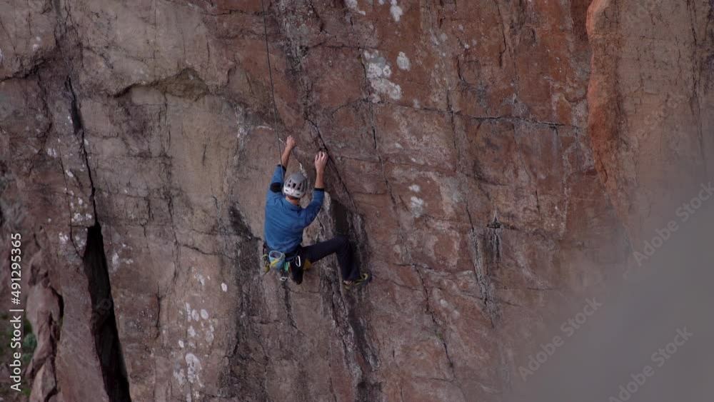 Drone aerial of man rock climbing on cliff Drone aerial of man rock climbing on cliff