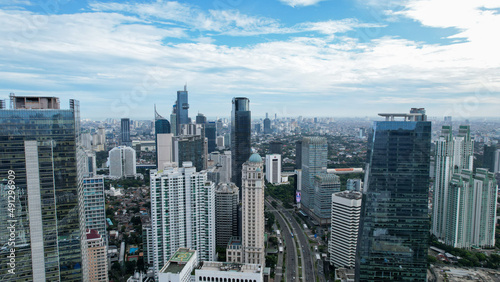 Aerial view of quiet traffic on Sudirman street with skyscrapers during weekend in Jakarta city. Jakarta, Indonesia, March 8, 2022