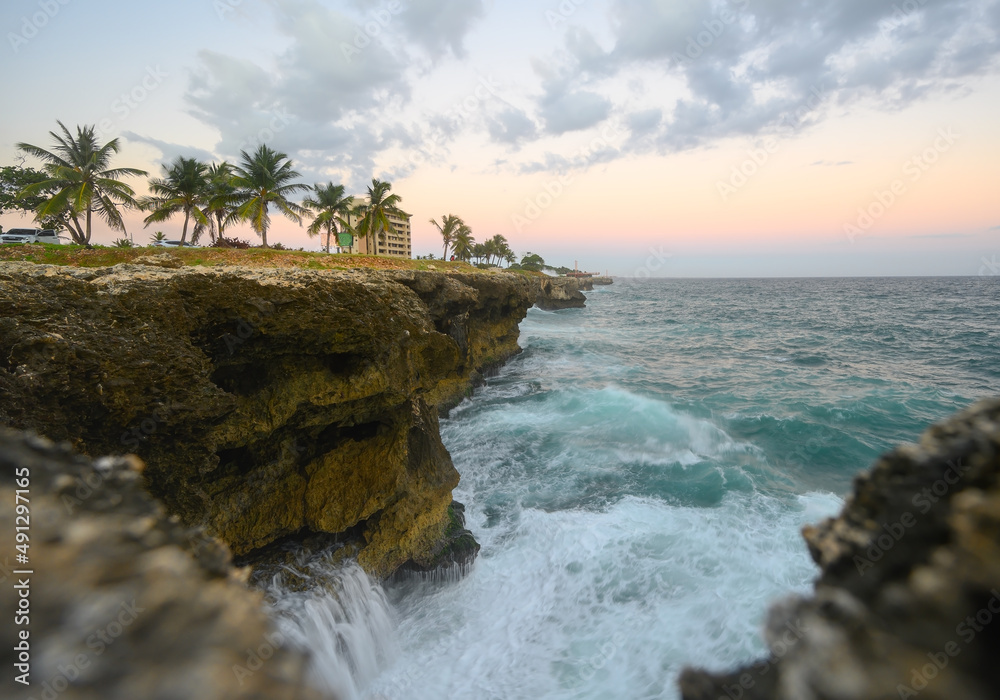 Raging ocean, rocky coast at sunset light. Caribbean travel destination Raging ocean, rocky coast at sunset light. Caribbean travel destination