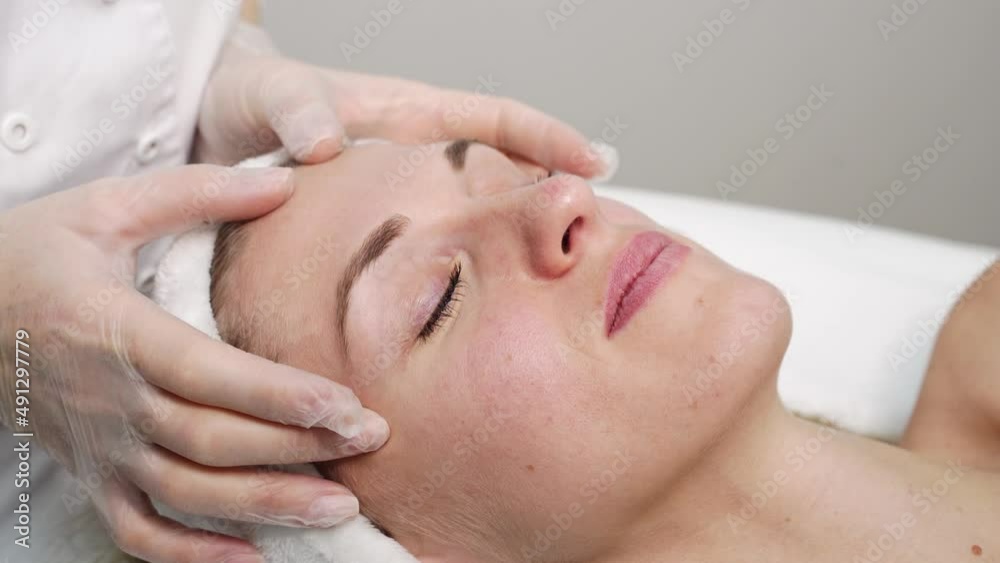 Female doctor exam person skin. Female patient consultation. Dermatology aesthetic surgery preparation. Spa salon facial treatment video. Luxury hospital check. Rejuvenation touch. Hands in gloves Female doctor exam person skin. Female patient consultation. Dermatology aesthetic surgery preparation. Spa salon facial treatment video. Luxury hospital check. Rejuvenation touch. Hands in gloves