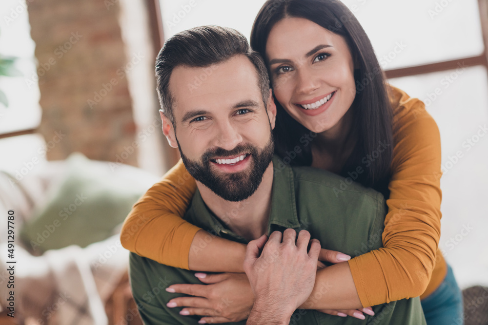 Portrait of attractive amorous cheerful couple hugging spending day daydream vacation pastime at home house flat indoors