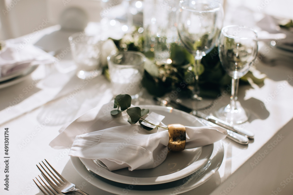 Elegant Place Setting with gold and white decoration in restaurant. Table set Elegant Place Setting with gold and white decoration in restaurant. Table set