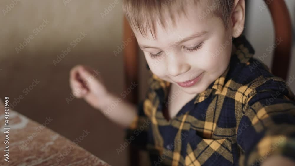 The child eats Chinese noodles with his hands The child eats Chinese noodles with his hands