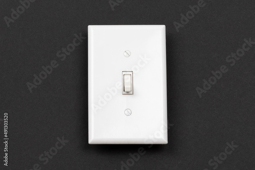 White light switch and white cover on black background