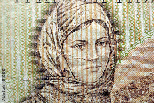 A portrait of a woman, girl in local traditional costume of Greece from the reverse side of 1000 one thousand Greek Drachmas Drachmai banknote currency issued 1970, old Greek money, vintage retro photo