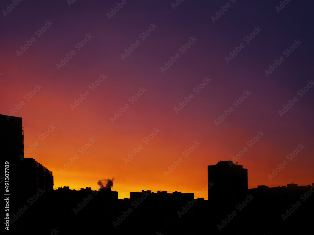 unrecognizable, typical, multi-storey house on the background of sunset, artistic light exposure