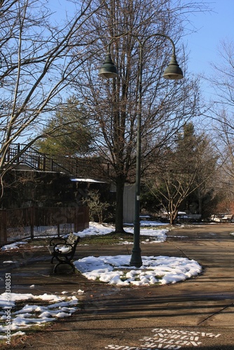 Bench and lamp post in park.
