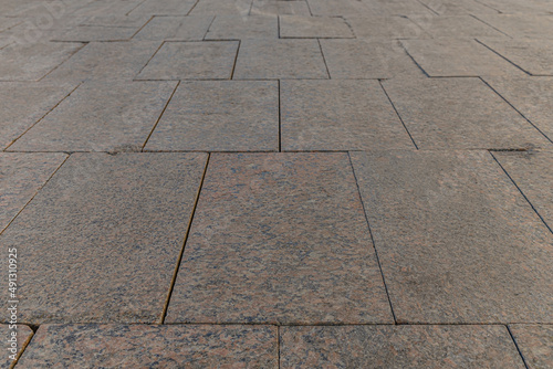 abstract background of a lined with granite tiles pavement perspective view