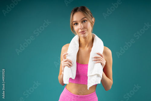 portrait of an attractive female in sportswear with a towel 