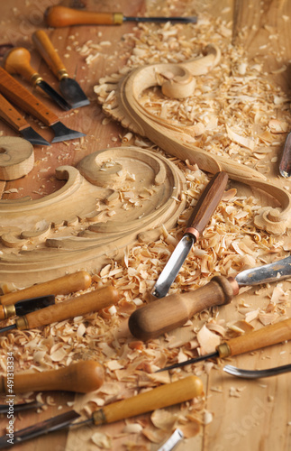 Carving wood with chisel. Carpenter's hands use chiesel