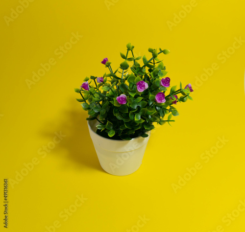 Fototapeta Naklejka Na Ścianę i Meble -  Artificial flower ornament on yellow background. spring concept.